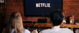 Мужчина и женщина смотрят телевизор с логотипом Netflix на экране